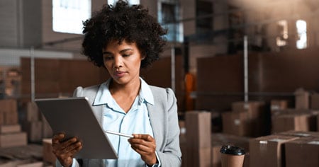 Woman small business owner sitting on desk